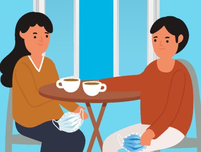 Two people having hot drinks together