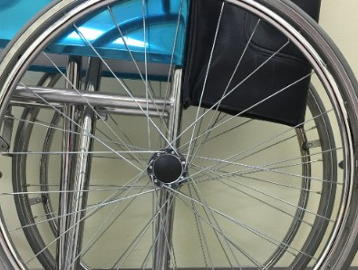 A close up image of the wheel of a wheelchair